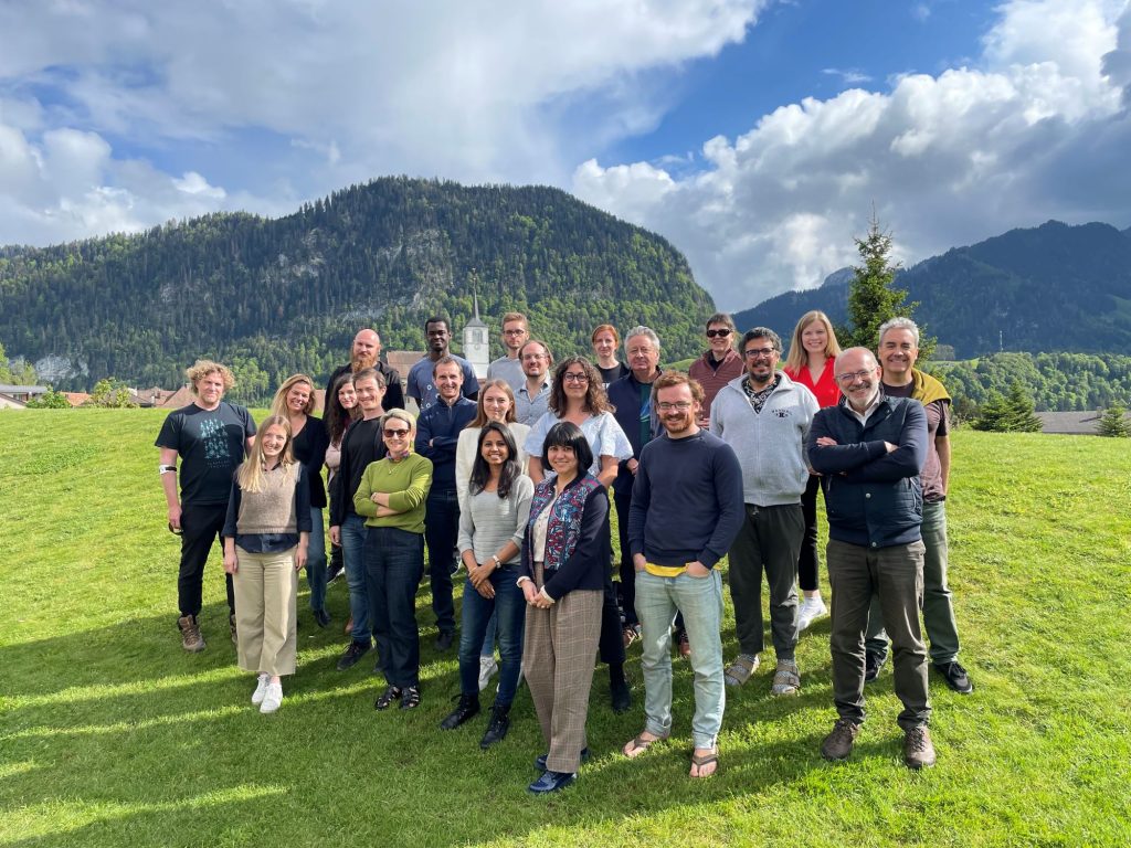 Group photo of all the participants at the QUANTA Spring 24 workshop. The green pre-alps of Charmey, Switzerland, in the background. 